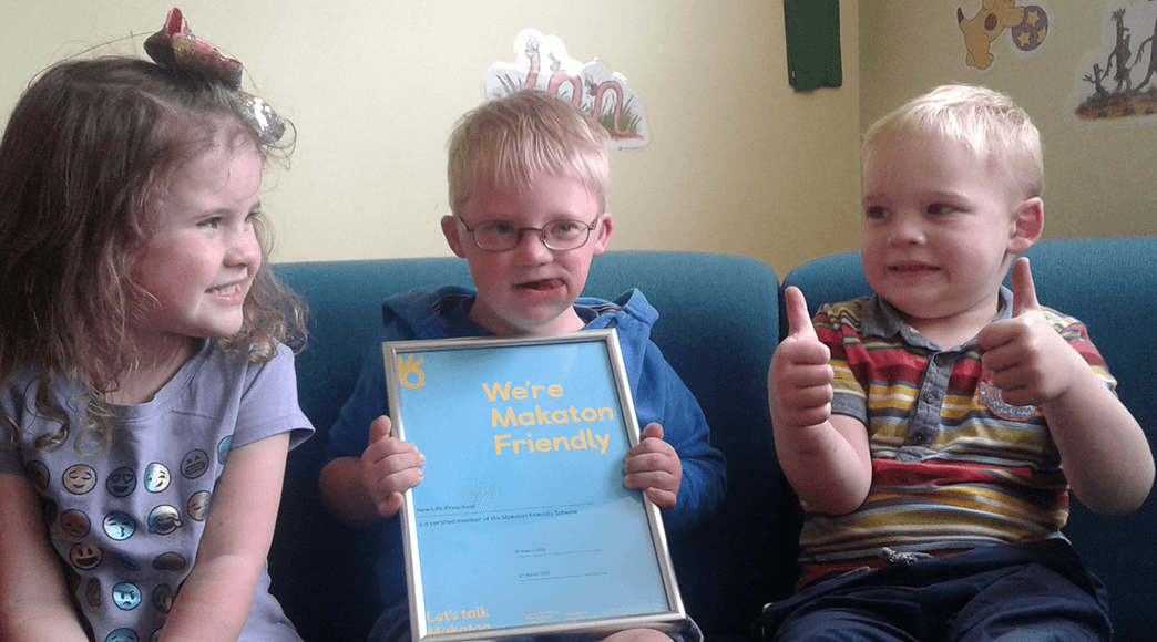 Children holding Makaton Friendly certificate