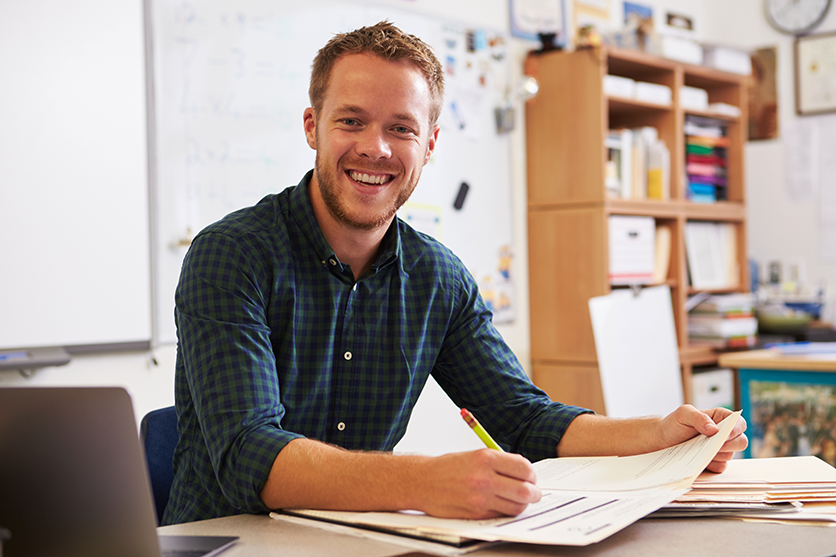 A young man sitting at a desk