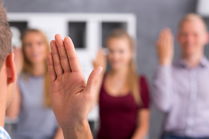 Group of people being taught a sign